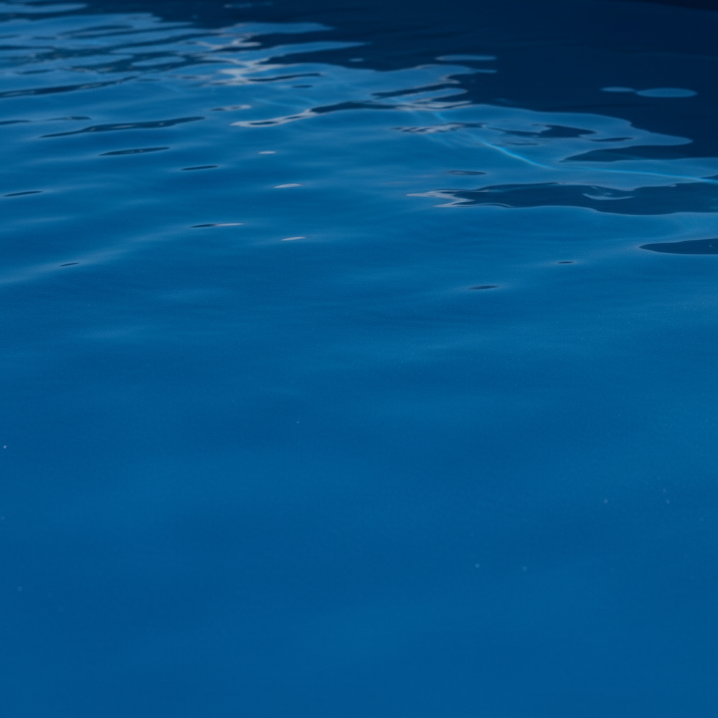 Tactile close-up of smooth continuous ecoFINISH polymer pool coating showing deep azure surface with no staining or rough texture